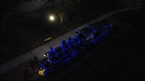 Vintage Steam Train Decorated with Blue Christmas Lights at Night