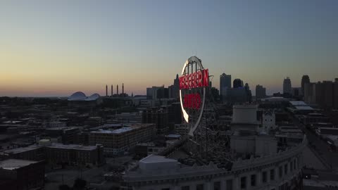 Lit Western Auto Sign over Kansas City Skyline at Sunset · Orbit