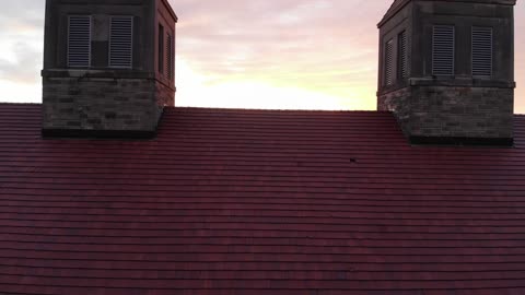 Tilt Up Reveal of American Flag at Sunrise in Lawrence Kansas