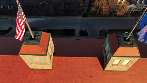 Twin Cupolas and Flags on a Campus Building · Orbit