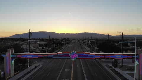 Freeway Toward Mountains at Sunset · Flyover