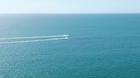 Jet Ski Speeding Across Deep Blue Ocean Water