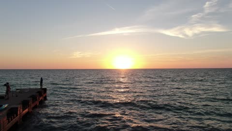 Sun Setting Over the Sea with Clouds