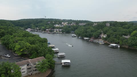 Boats and Jet Skis on a Forested Lake