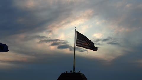 American Flag Waving Against a Dramatic Sky