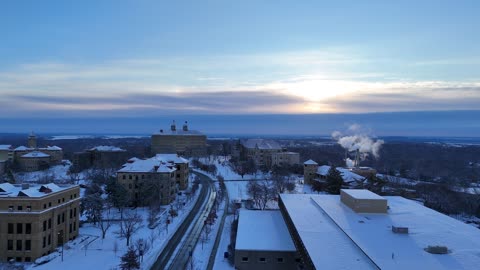 Jayhawk Boulevard and Fraser Hall on Campus · Snowy