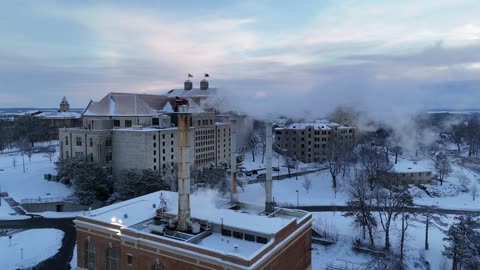 View of Steam Over a Snow-Covered KU Campus Building