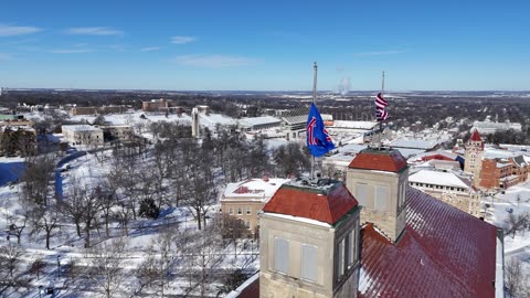 Fraser Hall and Flying Flags on the Snowy KU Campus