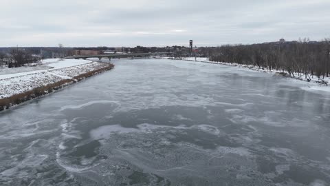 Downtown Lawrence Beyond the Icy Kansas River · Reveal