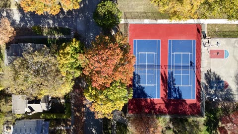 Tennis and Basketball Courts Among Autumn Trees