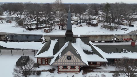 Freight Train Passing Through a Snowy Town