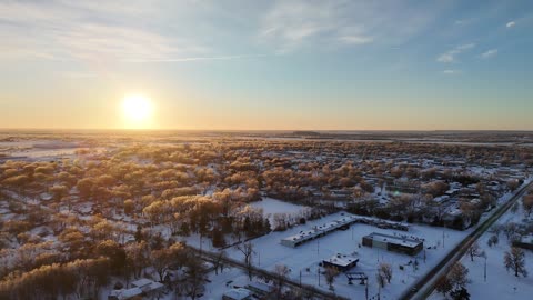 Snow-Covered Town at Winter Sunrise